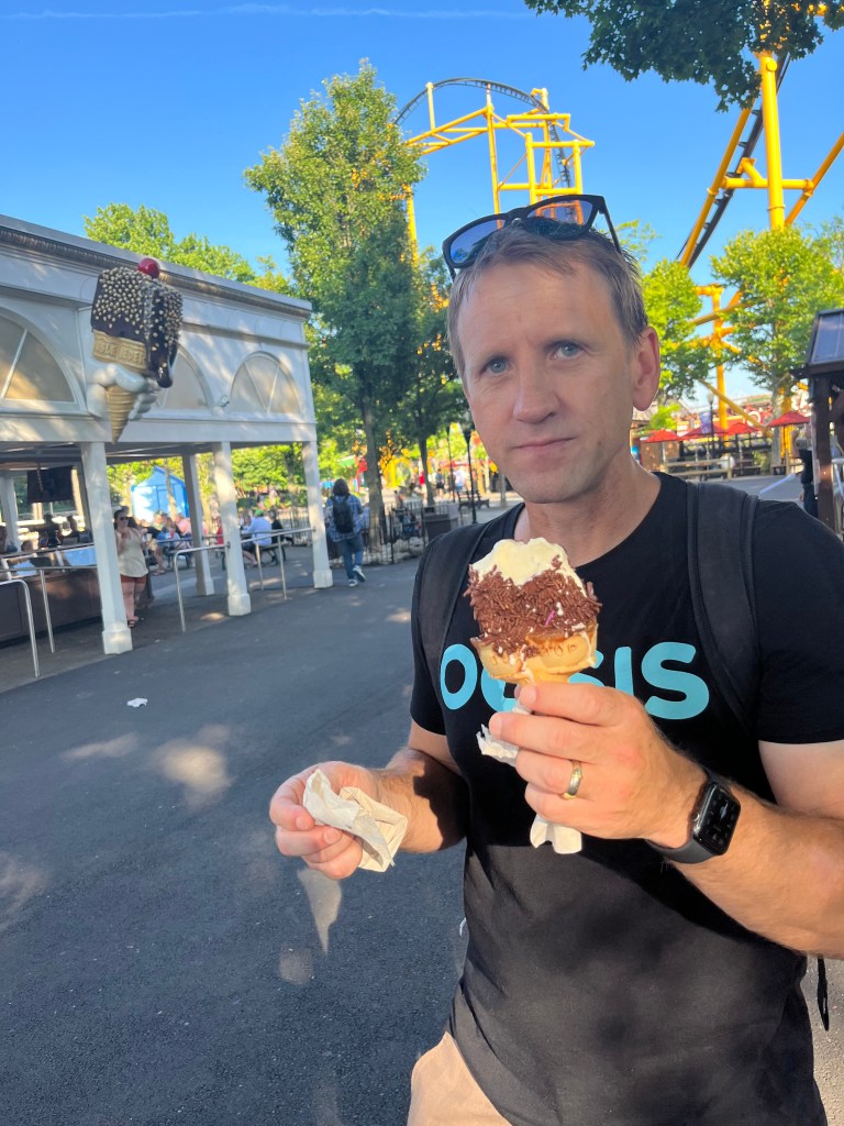 Dr. Walsh eating an ice cream cone at an amusement park